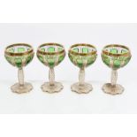 Four good quality 19th century Bohemian overlaid glass champagne coupe glasses with green panels