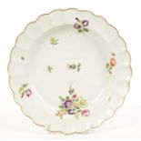 18th century Worcester fluted plate with polychrome floral spray decoration,