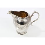 Victorian silver cream jug of inverted baluster form, with engraved foliate decoration,