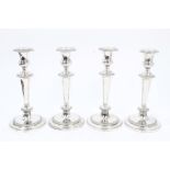 Set of four 19th century EPNS candlesticks with tapering columns, gadrooned borders,
