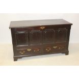 Early 18th century oak mule chest with hinged cover and four-fielded panel front,