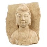 Antique Chinese carved stone relief bust of the Buddha, the stone with marble inclusions,