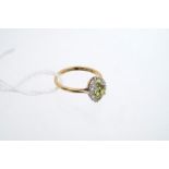 Diamond and peridot ring with a marquise-shape cluster set with three peridots and ten single cut