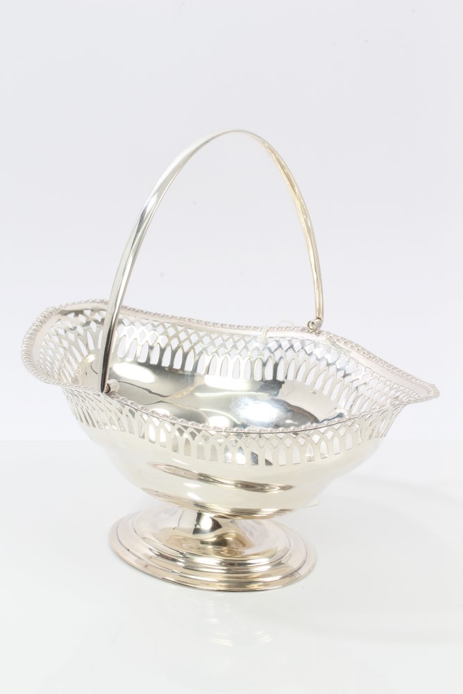 1920s silver swing-handled basket of shaped oval form, with pierced decoration and gadrooned border,