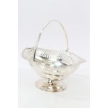 1920s silver swing-handled basket of shaped oval form, with pierced decoration and gadrooned border,