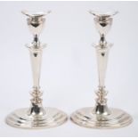 Pair contemporary silver batwing-style candlesticks with tapering columns,