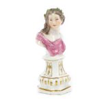 A Meissen small bust of a young lady with a laurel garland in her hair and puce robe,