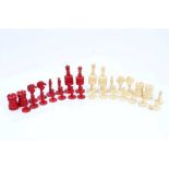 19th century carved and red stained bone chess set of large size, two pieces missing, queen 9.