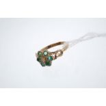 Victorian-style emerald flower-head cluster ring centered with a small diamond surrounded by six