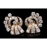Pair Art Deco diamond earrings, the stylised scroll set with old cut diamonds.