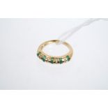 Gold (18ct) emerald and diamond ring, the band with alternating rows of emeralds and diamonds.