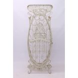 French Art Nouveau wirework wine rack of ovoid outline with lattice surmount,