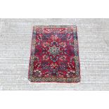 Small Eastern rug - with claret field centred by floral medallion and scrolling foliate in main