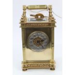 Late 19th century French brass carriage clock with ornate fluted and floral scroll decorated brass