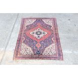 Persian rug - with concentric petalled medallions within foliate meander spandrels and multiple