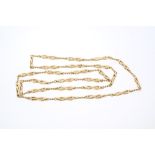 Yellow metal fancy link chain with a continuous length of ropetwist and openwork links,
