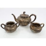Late 19th / early 20th century Chinese silver three piece tea set - comprising teapot of compressed