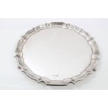 1930s silver salver of circular form, with piecrust border, on three pad feet (Sheffield 1937),