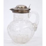 Edwardian silver mounted cut glass claret jug of bulbous form,
