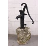 Antique cast iron pump mounted on natural stone base, 105cm high,