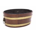 George III mahogany and brass bound wine cooler of oval tapered form,