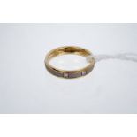 18ct white and yellow gold wedding / eternity ring with textured finish set with four diamonds.