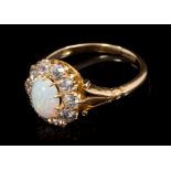 Victorian opal and diamond cluster ring with an oval cabochon opal surrounded by ten old cut