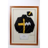 Racing Interest: A set of miniature Jockey silks mounted in a glazed frame,