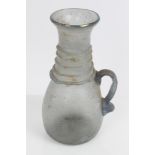 Ancient, possibly Roman, glass vessel with trailed neck and side loop handle with opalescent finish,