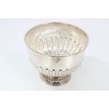 Late Victorian silver punch bowl of circular form, with half-fluted decoration,