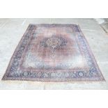 Large Kashan carpet - the claret field centred by petalled medallion within foliate spandrels and