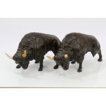 Pair of antique bronzed models of bison - each with ivory horns,