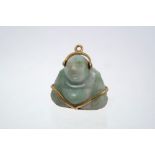 Chinese carved jade figure of a Buddha, with gold (18ct) mounts,