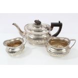 Late Victorian silver three piece tea set - comprising teapot of half-fluted form,