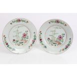 Pair 18th century Chinese export famille rose plates with floral and fence decoration,