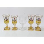 Four late 19th century Bohemian amber overlaid wine glasses with painted polychrome figure and