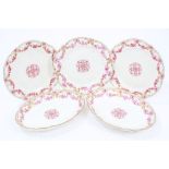 Three 18th century Sèvres porcelain plates with puce and gilt floral swag and ribbon decoration and