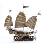 Late 19th century white metal model of an armed Junk with three sails, flags,
