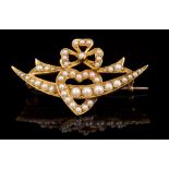 Victorian seed pearl brooch with a heart and crescent design, surmounted by a ribbon bow,