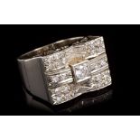 Art Deco-style white gold and diamond set ring with central brilliant cut diamond flanked by pavé