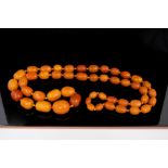 Large amber bead necklace with a string of oval butterscotch amber graduated beads,