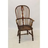 19th century ash and elm Windsor elbow chair with pierced stick back and solid saddle seat raised