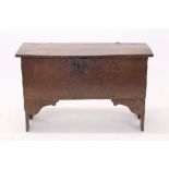 17th century six-plank coffer with plank top and early iron lock plate, raised on V-cut ends,