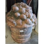 Antique terracotta garden ornament modelled as a ribbed bucket spilling over with fruit,