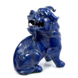 19th century Chinese blue glazed porcelain Dog of Foo with head turned rearward,