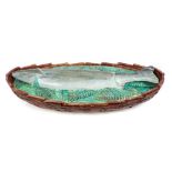 Victorian George Jones Majolica fish dish and cover decorated in relief with a trout on leaves,