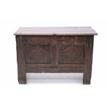 Small-size carved oak coffer with hinged plank lid and lunette carved frieze over two-panel lozenge