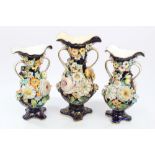 Garniture of three mid-19th century Coalport floral encrusted vases - each with twin scroll handles,