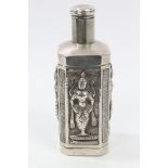 Indian white metal scent bottle of octagonal form, with embossed panels depicting the deities,
