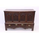 Early 18th century oak mule chest with hinged top over quadruple fielded arch panel front over